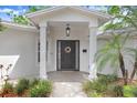 Welcoming front entrance featuring a covered porch and stylish front door with wreath at 10513 Carrollview Dr, Tampa, FL 33618