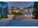 Stunning two-story home with a modern design, manicured landscaping, and an inviting entrance at 108 Peterson Ln, Palm Harbor, FL 34683