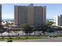 Beautiful condo building with parking, palm trees, and beach access offers luxury coastal living at 1270 Gulf Blvd # 1901, Clearwater Beach, FL 33767