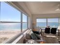 Bright living room with cozy seating and expansive ocean views from large windows at 1270 Gulf Blvd # 1901, Clearwater Beach, FL 33767