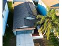 Aerial shot of a home featuring solar panels, a driveway, and lush landscaping, offering curb appeal at 12720 Hampton Hill Dr, Riverview, FL 33578