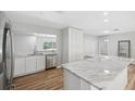 Modern kitchen featuring stainless steel appliances, marble counters, and wood-look floors at 1555 Newhope Rd, Spring Hill, FL 34606
