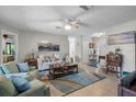 Cozy living room with neutral walls, tile floors, comfortable seating, and stylish decor at 1762 Atrium Dr, Sun City Center, FL 33573