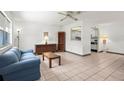 Inviting living room with tile floors and a pass-through to the kitchen at 1802 Bedford Ln # 7, Sun City Center, FL 33573