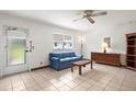 Comfortable living room with tile flooring and access to the outdoors at 1802 Bedford Ln # 7, Sun City Center, FL 33573