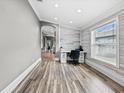 Bright home office featuring a modern desk, stylish accent wall and light wood floors at 18516 Snowdonia Dr, Land O Lakes, FL 34638