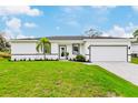 Well maintained home exterior with an attached garage and a pristine lawn at 18773 Lake Worth Blvd, Port Charlotte, FL 33948