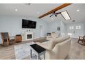 Bright living room featuring vaulted ceiling, a fireplace, and ample seating at 1913 Libby Ct, Holiday, FL 34690