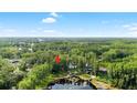 A beautiful aerial view of the property nestled within a vibrant, dense green forest, indicating privacy at 22004 Dupree Dr, Land O Lakes, FL 34639