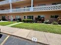 A condo's inviting outdoor space featuring a well-manicured lawn and cozy seating area for relaxation at 2457 Ecuadorian Way # 27, Clearwater, FL 33763