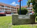 English Gothic condo complex with manicured lawn and visible signage for easy identification at 2457 Ecuadorian Way # 27, Clearwater, FL 33763