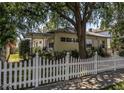 Side view of a cozy home featuring a welcoming porch and charming white picket fence at 2710 10Th N St, St Petersburg, FL 33702