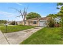 Lovely single-story home featuring an attached garage and spacious driveway, ready for personalization at 3559 Rock Royal Dr, Holiday, FL 34691