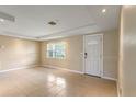 Bright living room featuring tile floors, neutral walls, and a window for natural light at 3559 Rock Royal Dr, Holiday, FL 34691