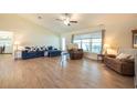 Open concept living room features modern furnishings, wood floors and cathedral ceiling at 3642 Fantasy Way, Brooksville, FL 34604