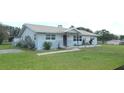 A single-story home with a stone facade, showcasing the front yard and exterior features at 38535 Clinton Ave, Dade City, FL 33525