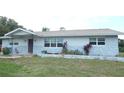 Charming single-story home featuring a stone facade, well-maintained lawn, and a welcoming front entrance at 38535 Clinton Ave, Dade City, FL 33525
