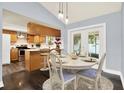 Bright dining area adjacent to kitchen featuring sliding glass doors to the backyard and pendant lighting at 4307 Shadberry Dr, Tampa, FL 33624