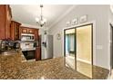 A kitchen featuring granite countertops, stainless steel appliances and ample cabinet space in a well-lit area at 4419 Longshore Dr, Land O Lakes, FL 34639