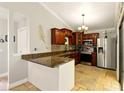 Spacious kitchen with stone floors, modern appliances, and beautiful cabinetry, perfect for cooking and entertaining at 4419 Longshore Dr, Land O Lakes, FL 34639