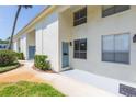 Exterior showing units with light-colored walls and blue doors at 4517 La Capri Ct, Tampa, FL 33611
