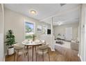 Bright dining area with a modern table and chairs, and views into the living room at 4804 N 18Th St, Tampa, FL 33610