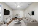 Bright living room featuring a modern sofa, stylish decor, and a ceiling fan at 4804 N 18Th St, Tampa, FL 33610