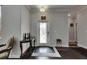 Elegant foyer featuring dark hardwood floors and a decorative glass front door at 5057 Ivory Stone Dr, Wimauma, FL 33598