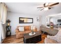 Inviting living room featuring a cozy leather sofa, modern decor and hardwood floors at 5149 4Th St, Zephyrhills, FL 33542