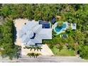 Beautiful aerial view of the home, highlighting the backyard pool, patio area, and lush landscaping at 540 Gulf Bay Rd, Longboat Key, FL 34228