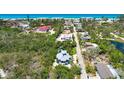 Gorgeous aerial view featuring surrounding neighborhood and beach nearby this lovely home at 540 Gulf Bay Rd, Longboat Key, FL 34228
