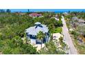 Charming home with a two-car garage and lush landscaping, offering a serene and private setting at 540 Gulf Bay Rd, Longboat Key, FL 34228