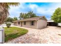 Charming single-story home with brick driveway, manicured lawn, fenced yard and an attached garage at 6423 Boxwood St, Brooksville, FL 34602