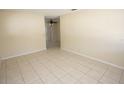 Spacious living room boasts neutral walls, tile flooring, and a ceiling fan visible through an opening at 6514 La Mesa Cir, Tampa, FL 33634