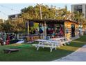 Outdoor recreation area with a bar, picnic tables, and lawn games for community entertainment at 800 Cove Cay Dr # 4F, Clearwater, FL 33760