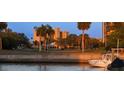 Picturesque waterfront view showcasing lush landscaping, nearby golf course, and docked boats at 800 Cove Cay Dr # 4F, Clearwater, FL 33760