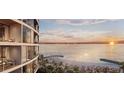 Beautiful sunset ocean view from an exterior balcony with lounge seating at 805 S Gulfview Blvd # 506A, Clearwater, FL 33767