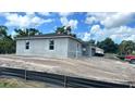 New home showing the side and front on a large lot with a partially obscured two-car garage at 9149 Willmington Blvd, Englewood, FL 34224