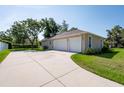 Spacious three-car garage with ample parking space and driveway at 9908 Alafia River Ln, Gibsonton, FL 33534