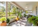 Relaxing screened-in porch with ceiling fans and peaceful outdoor views at 9908 Alafia River Ln, Gibsonton, FL 33534