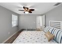 Bright bedroom featuring a ceiling fan, natural light, and a comfortable bed with decorative pillows at 10011 46Th W Ave, Bradenton, FL 34210