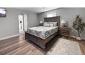 Serene main bedroom with wood floors, neutral colors, and a large bed with stylish bedside tables at 10011 46Th W Ave, Bradenton, FL 34210