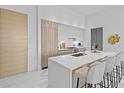 Sleek kitchen featuring a large island with bar seating and modern cabinetry at 1020 Sunset Point Rd # 712, Clearwater, FL 33755