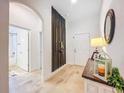 Hallway featuring wood floors, console table, and a doorway to a tiled bathroom with shower at 12010 Jackson Landing Pl, Tampa, FL 33624