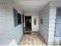 Charming entryway with tile floors, white brick, and muted blue shutters at 12055 4Th E St, Treasure Island, FL 33706
