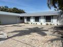 Charming single-story home with a neutral color palette and a spacious brick driveway at 12055 4Th E St, Treasure Island, FL 33706