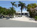 Charming single story home with tropical landscaping and white rock accents at 12055 4Th E St, Treasure Island, FL 33706