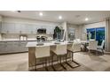 Open-concept kitchen flows into a dining area, featuring an island with seating and stainless appliances at 12842 Canter Call Rd, Lithia, FL 33547