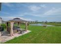 Inviting backyard with a gazebo, outdoor seating, and peaceful pond views for relaxation and enjoyment at 14643 Brumby Ridge Ave, Lithia, FL 33547
