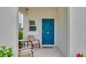 Welcoming front porch with seating, a bright blue door, and decorative accents for a cozy entry at 14643 Brumby Ridge Ave, Lithia, FL 33547